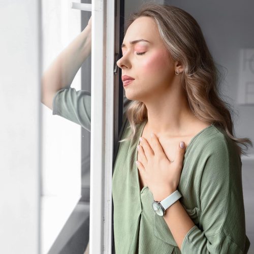 Young,Woman,Having,Panic,Attack,Near,Window